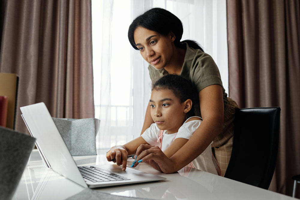 mother daughter at computer