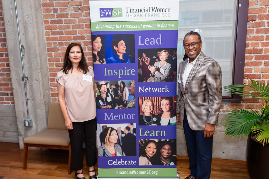 Attendees standing next to FWSF banner