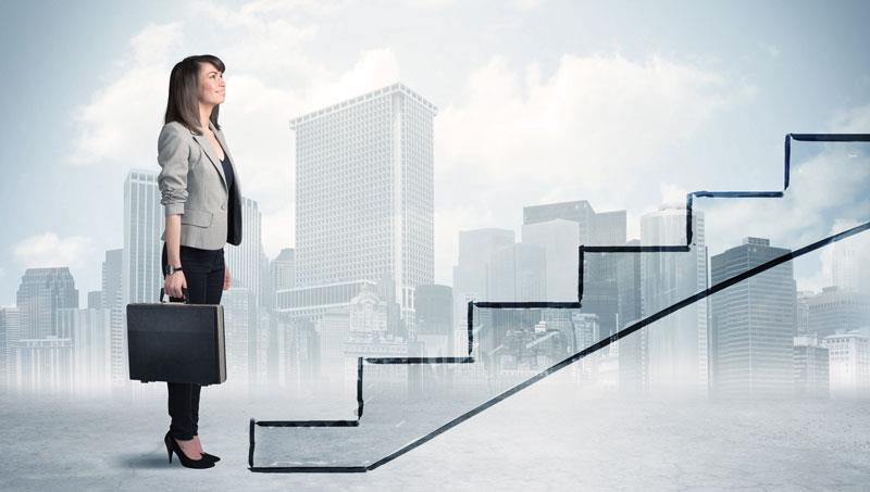 Woman going up career staircase