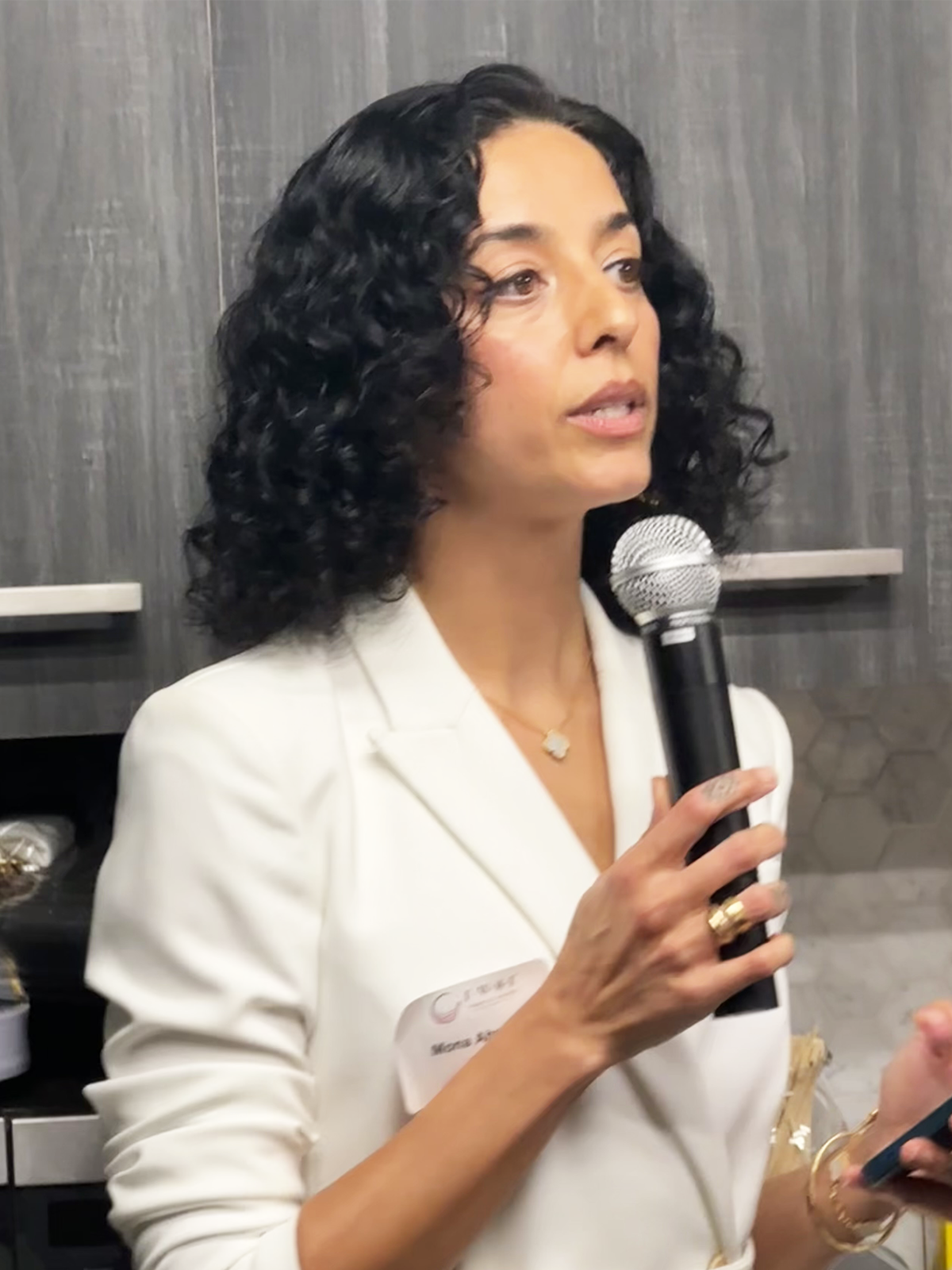 woman speaking holding microphone