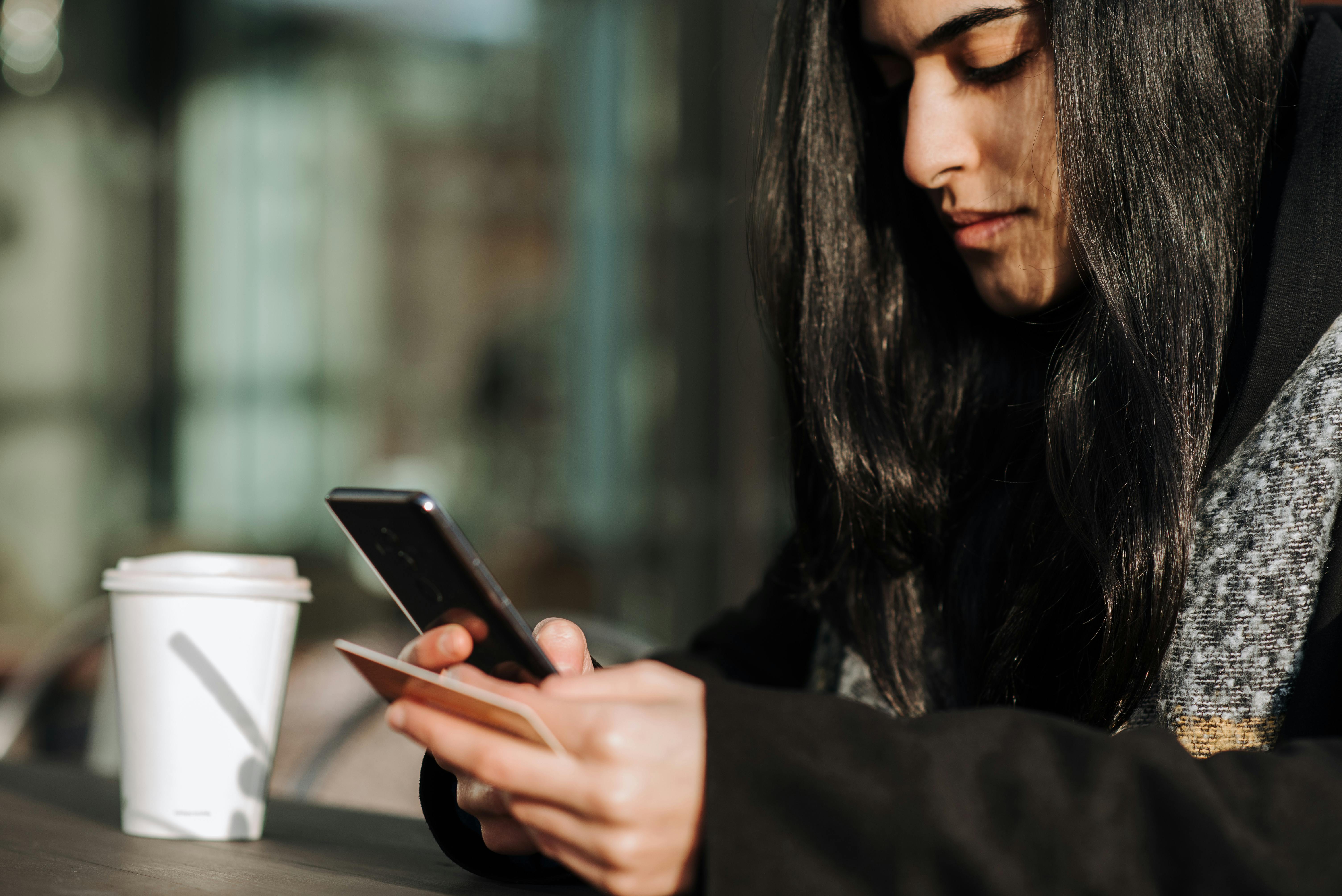 Woman giving money using a credit card and her photo